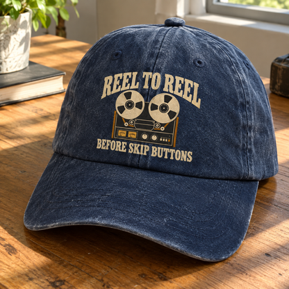 Navy vintage washed cap with printed reel-to-reel design and Reel To Reel slogan, angled view