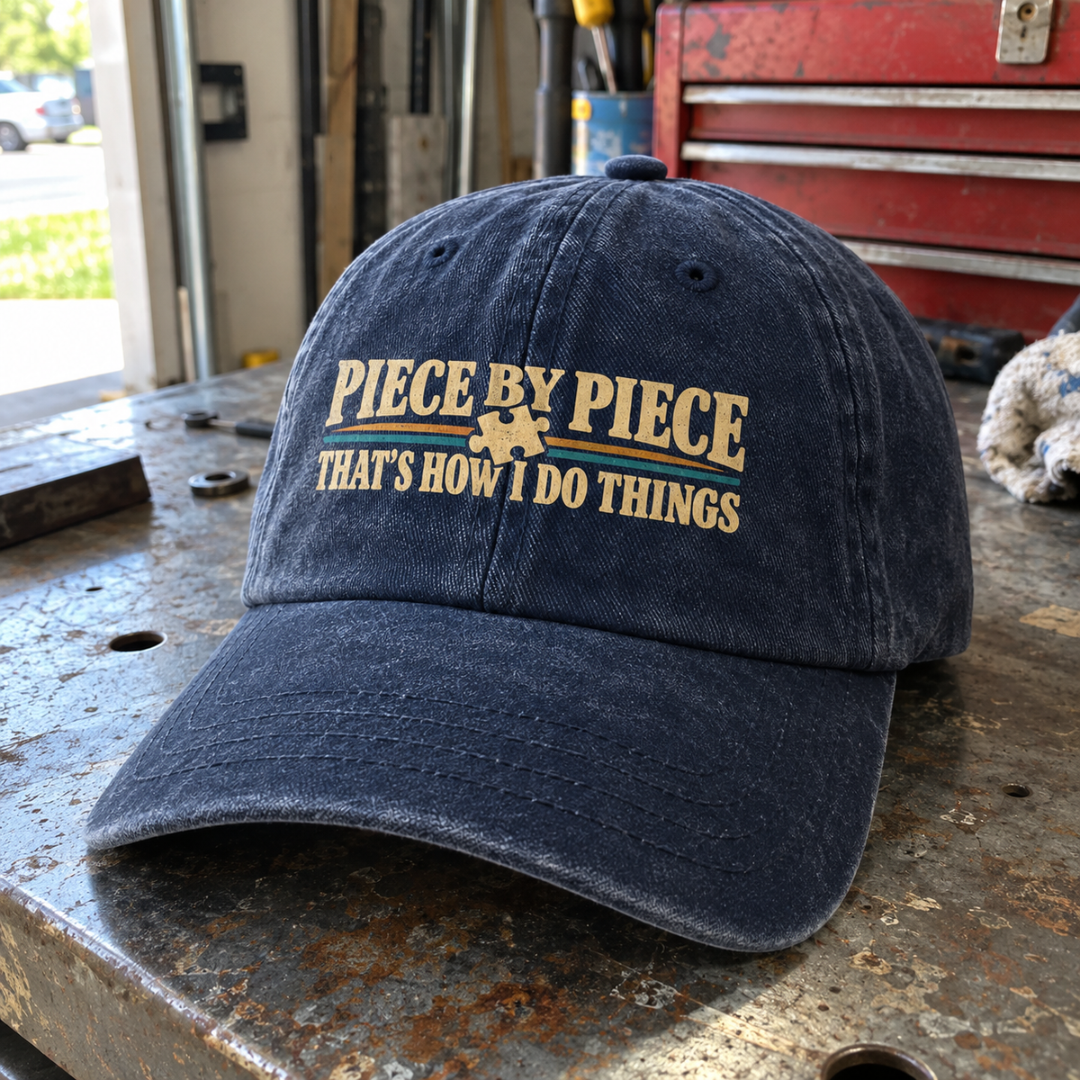 Vintage washed cap with printed “Piece By Piece. That's How I Do Things” design, angled view.