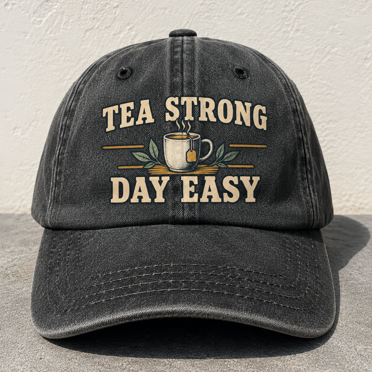 Black vintage washed cap with printed Tea Strong Day Easy slogan front angle