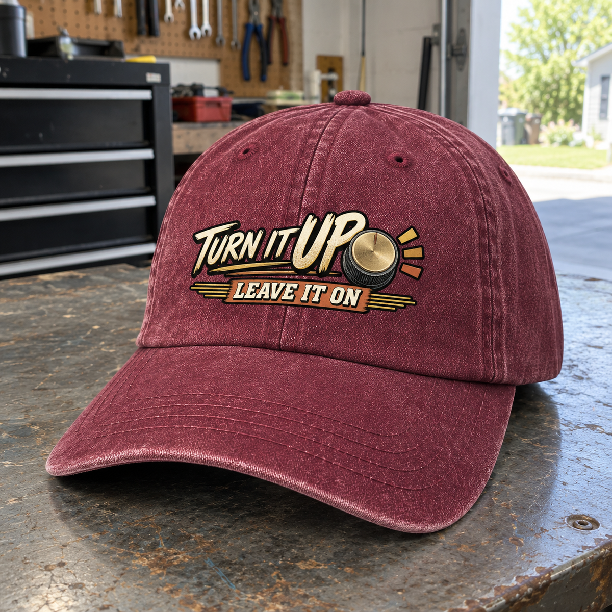 Burgundy vintage washed cap with printed Turn It Up. Leave It On slogan, angled view
