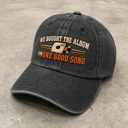 Vintage washed cap with printed “We Bought The Album For One Good Song,” angled view