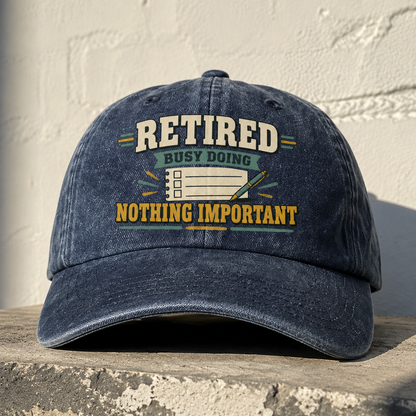 Navy vintage washed cap angled view with printed Retired Busy Doing Nothing Important slogan