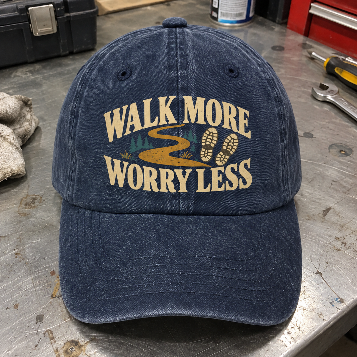 Navy vintage washed cap with printed Walk More. Worry Less hiking trail design, front angle.