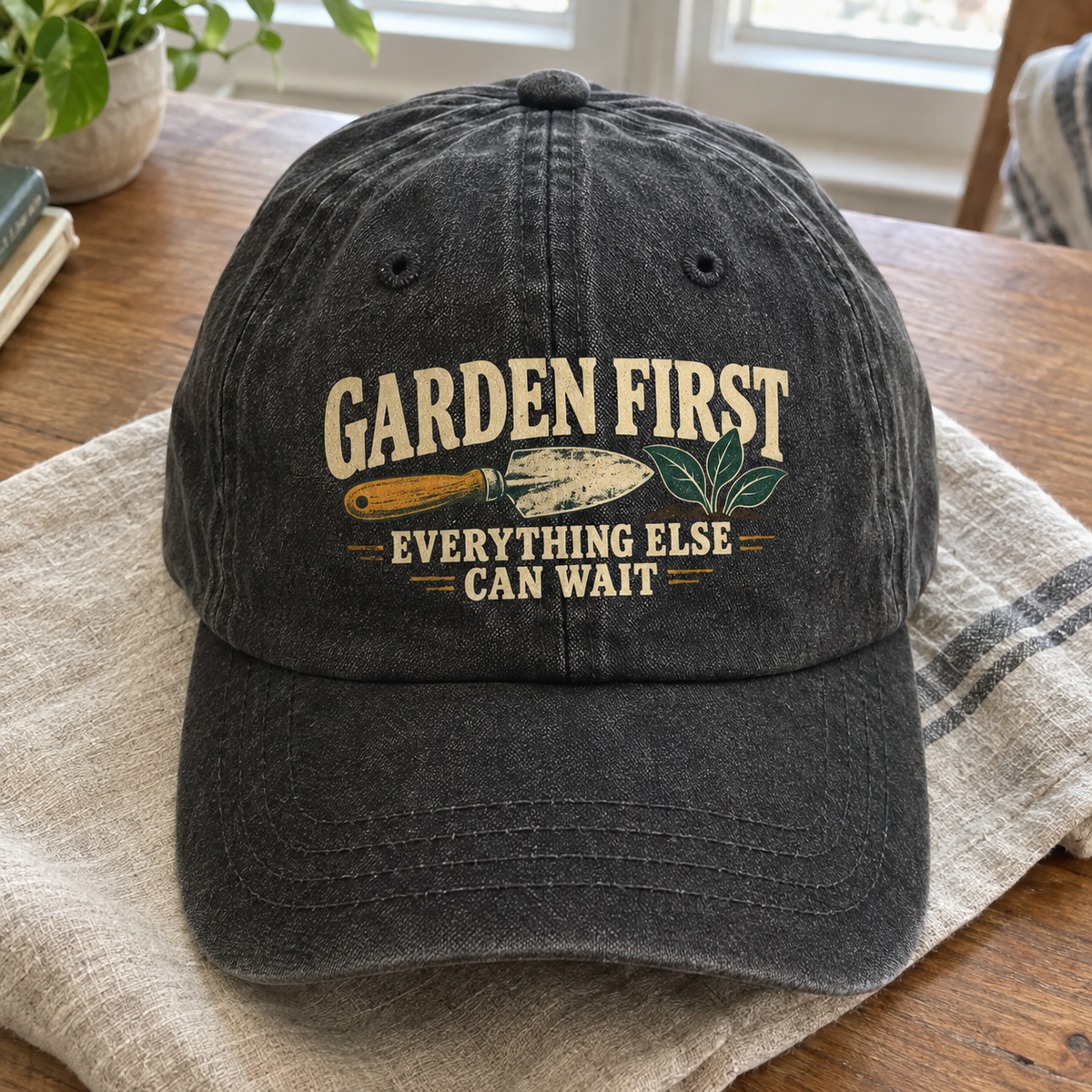 Black vintage washed cap with printed Garden First. Everything Else Can Wait slogan, front angle