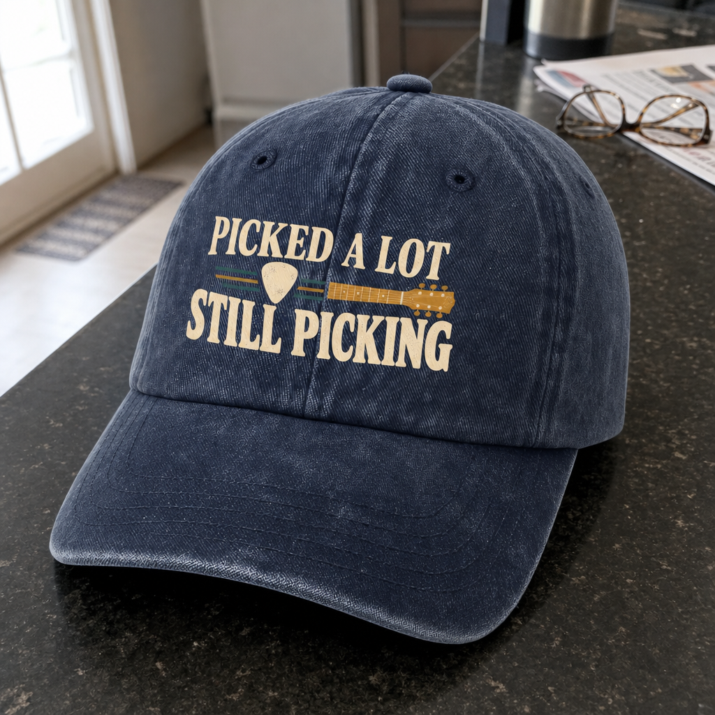 Navy vintage washed cap with printed Picked A Lot Still Picking slogan, angled view.