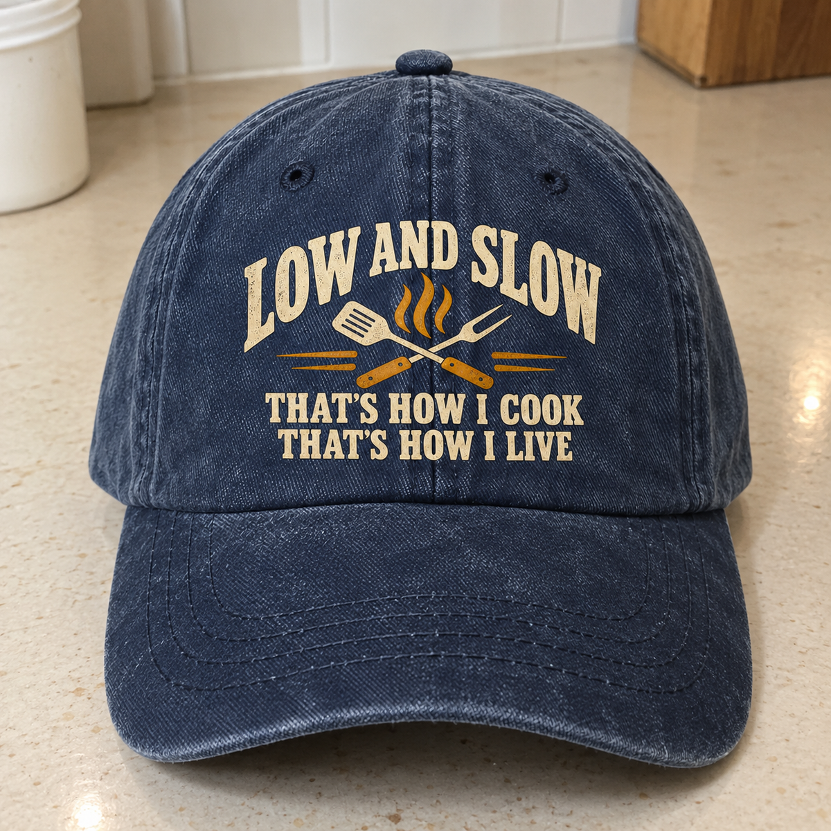 Vintage washed cap in navy with printed Low And Slow cooking slogan, front angle view