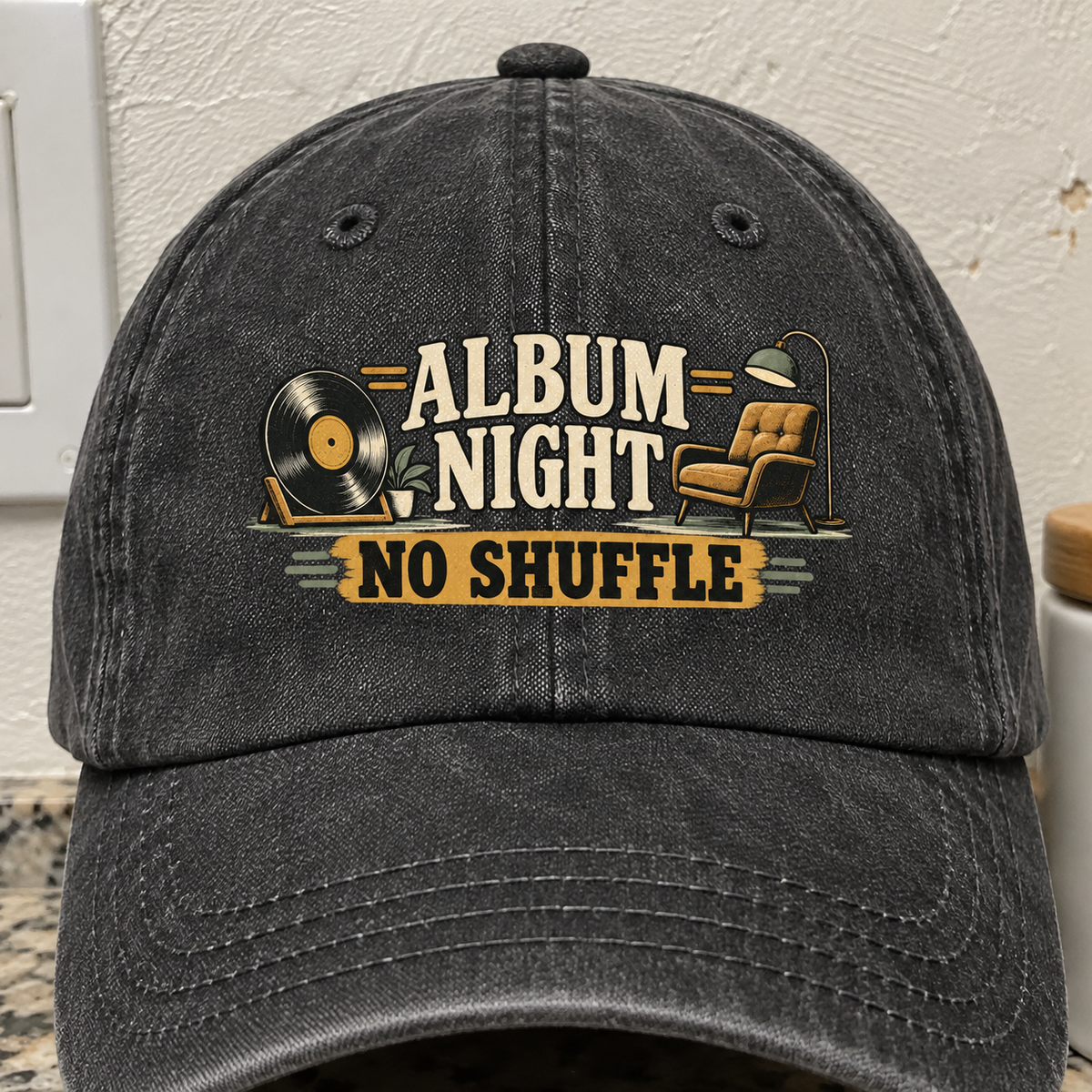 Black vintage washed cap with printed “Album Night. No Shuffle” record player design, front angle.
