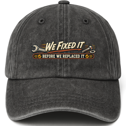 Black vintage washed cap with We Fixed It Before We Replaced It printed front design