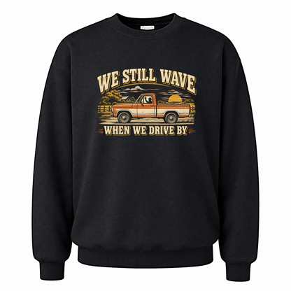 Black vintage sweatshirt with We Still Wave When We Drive By printed front design