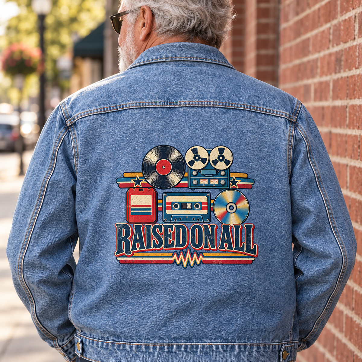 Senior man in blue vintage denim jacket, back view, printed Raised On All music design.