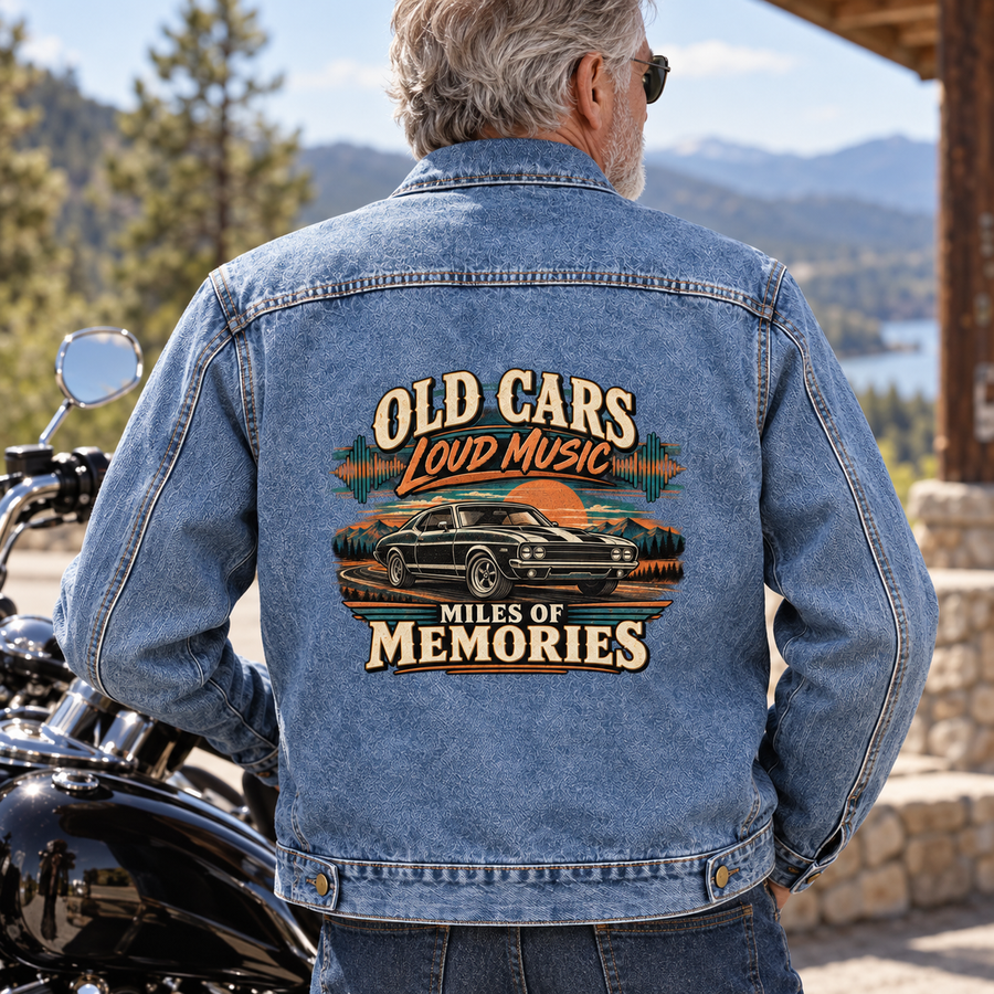 Senior man wearing blue vintage denim jacket with printed car design beside motorcycle