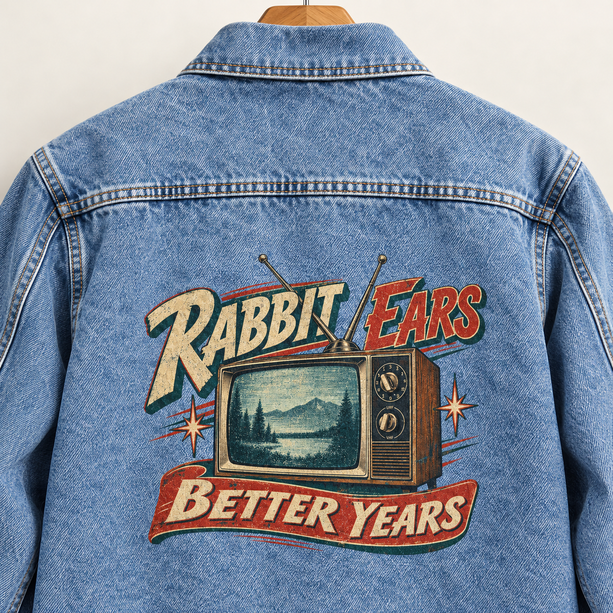Back view of blue vintage denim jacket with printed television and Rabbit Ears. Better Years slogan