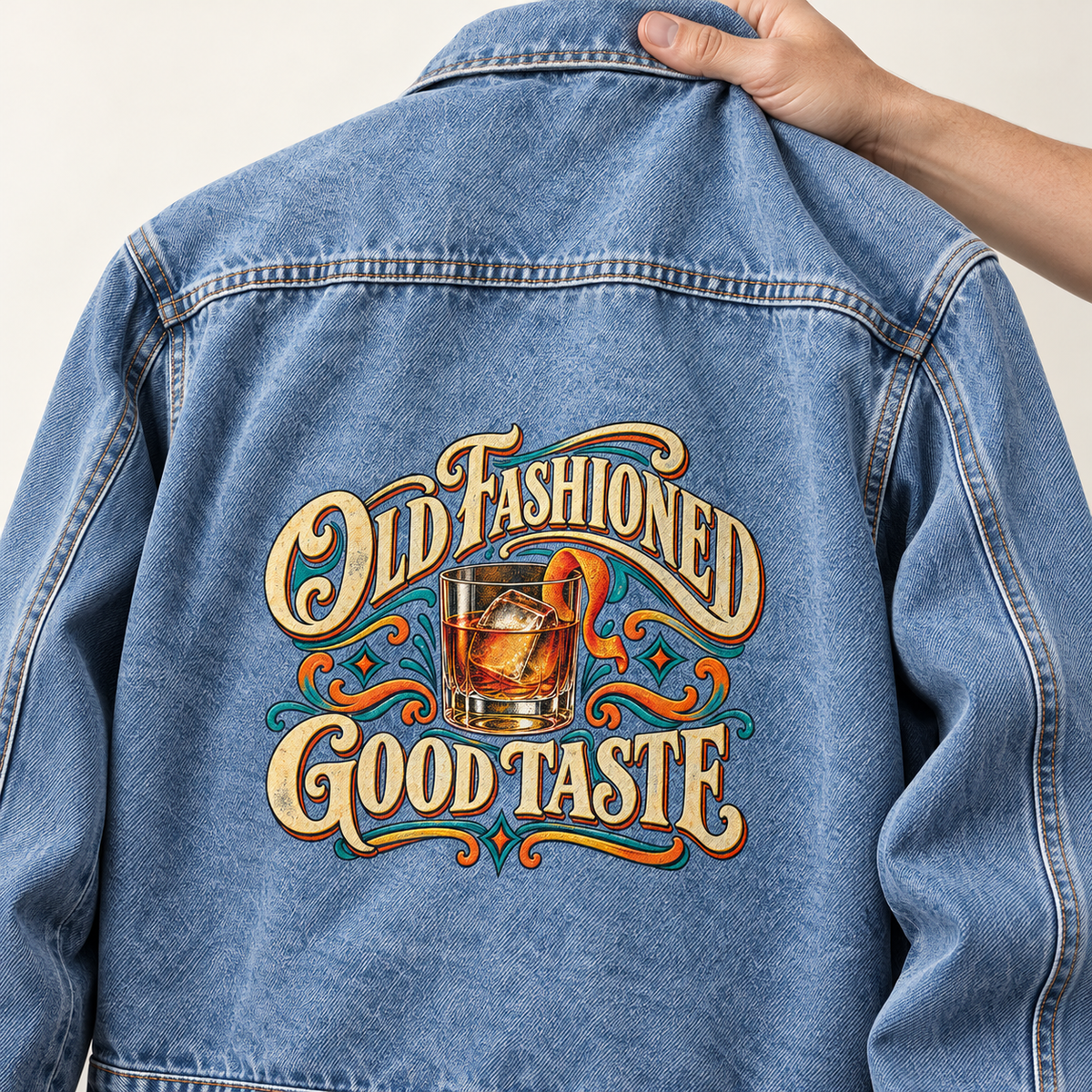 Back view of blue vintage denim jacket with printed Old Fashioned Good Taste cocktail design