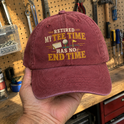Burgundy vintage washed cap with printed Retired My Tee Time slogan, handheld view