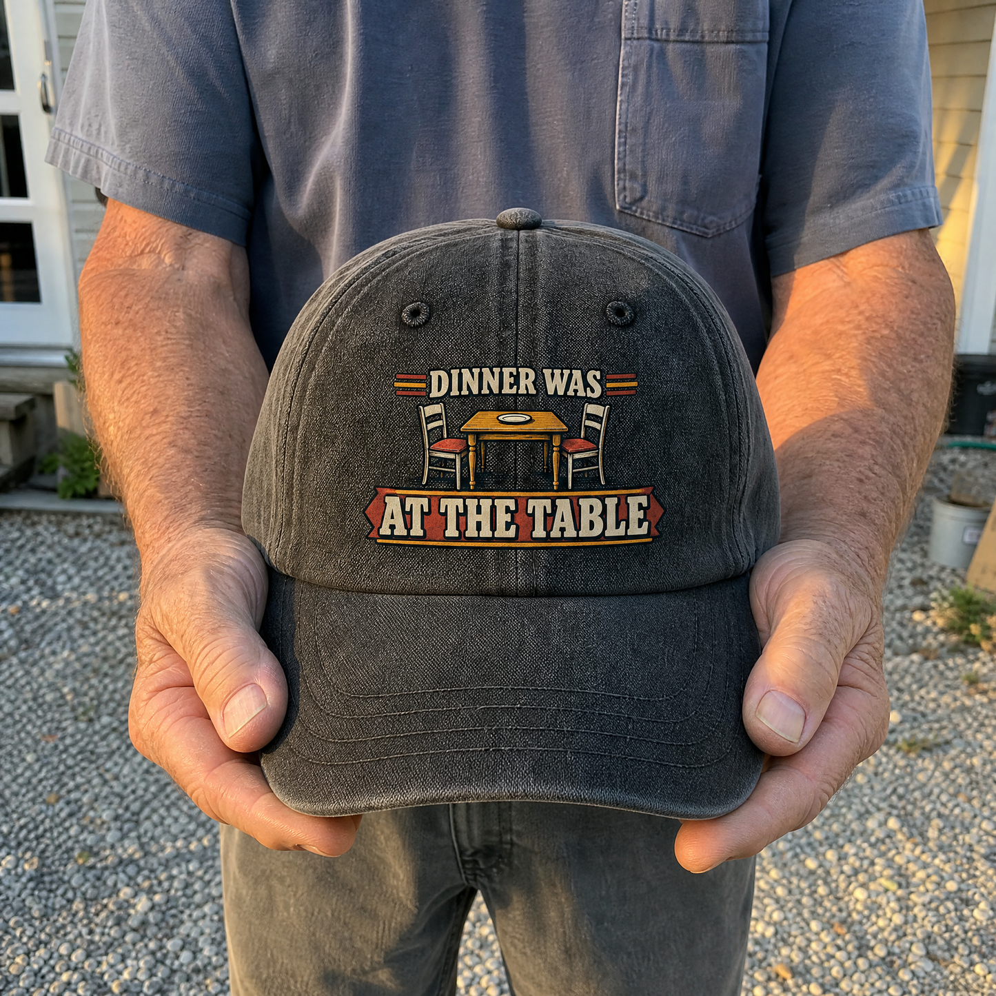 Vintage washed cap with printed “Dinner Was At The Table” held by an older man.