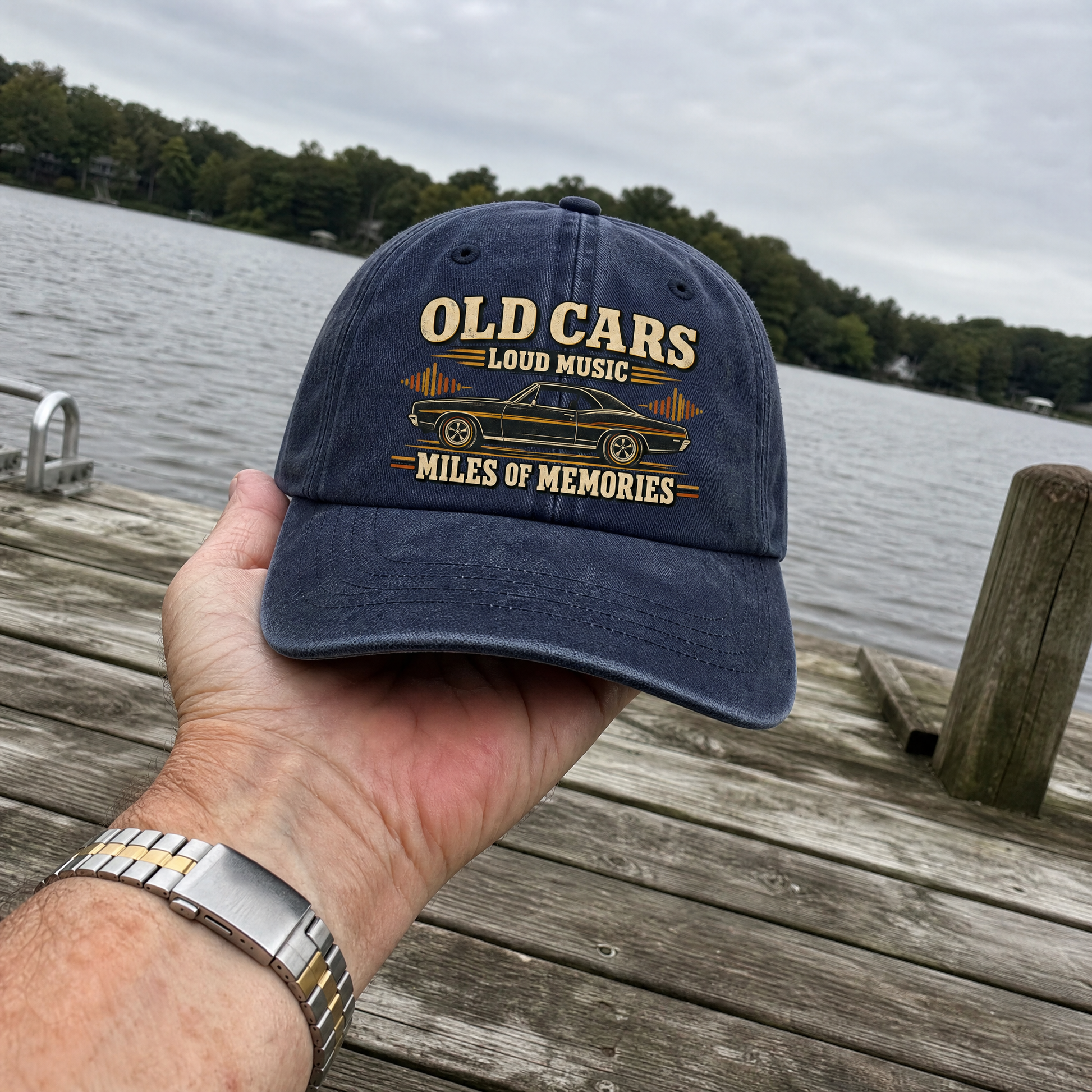 Vintage washed cap with printed “35 old cars loud music miles of memories” design, handheld view