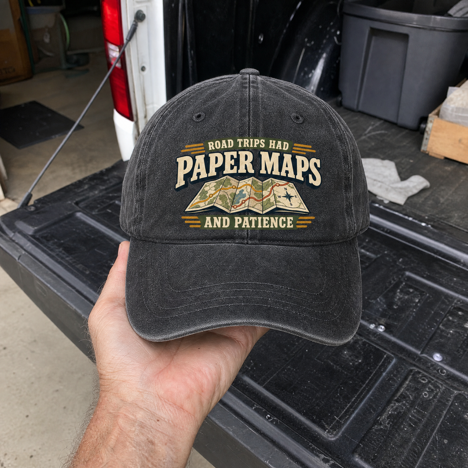 Black vintage washed cap with printed Road Trips Had Paper Maps And Patience slogan, handheld view
