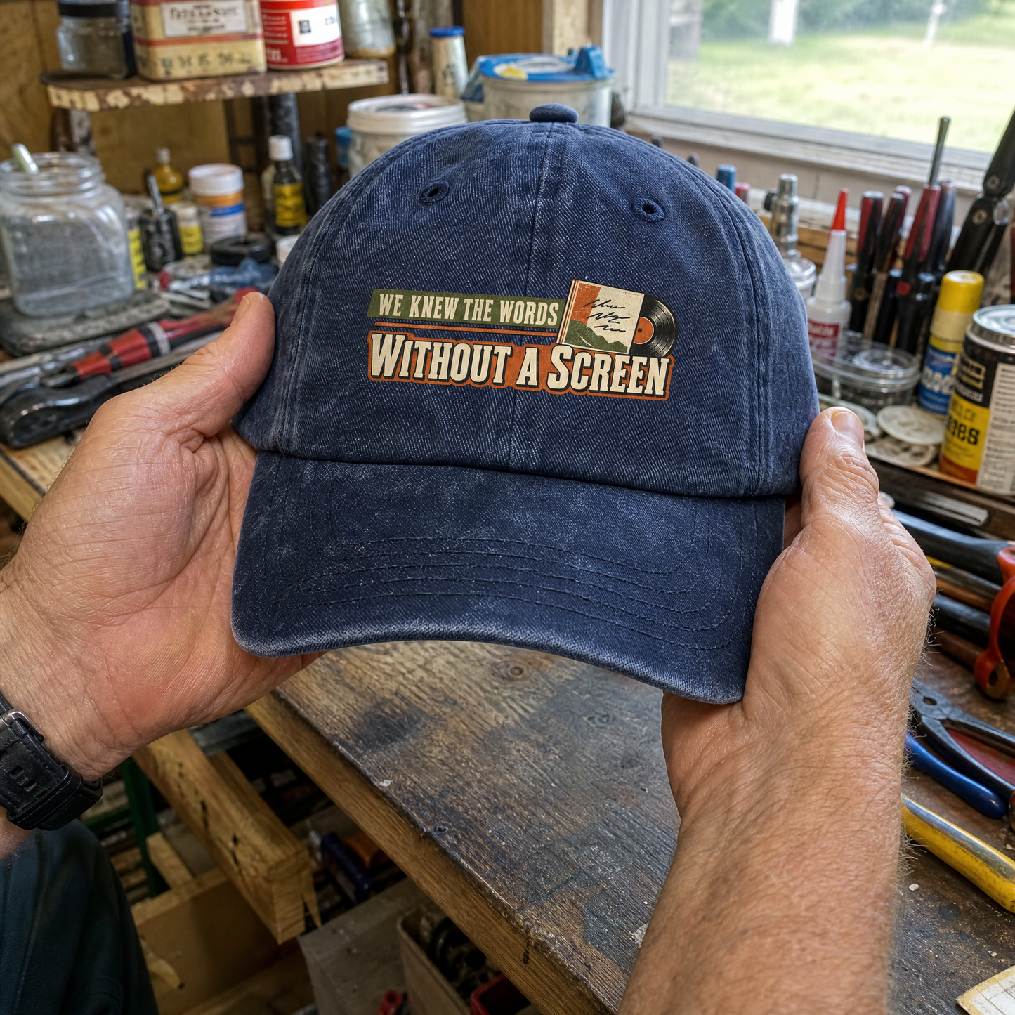 Navy vintage washed cap with printed “We Knew The Words Without A Screen” slogan, handheld front view