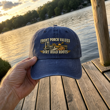 Handheld blue vintage washed cap with printed Front Porch Values Dirt Road Roots design