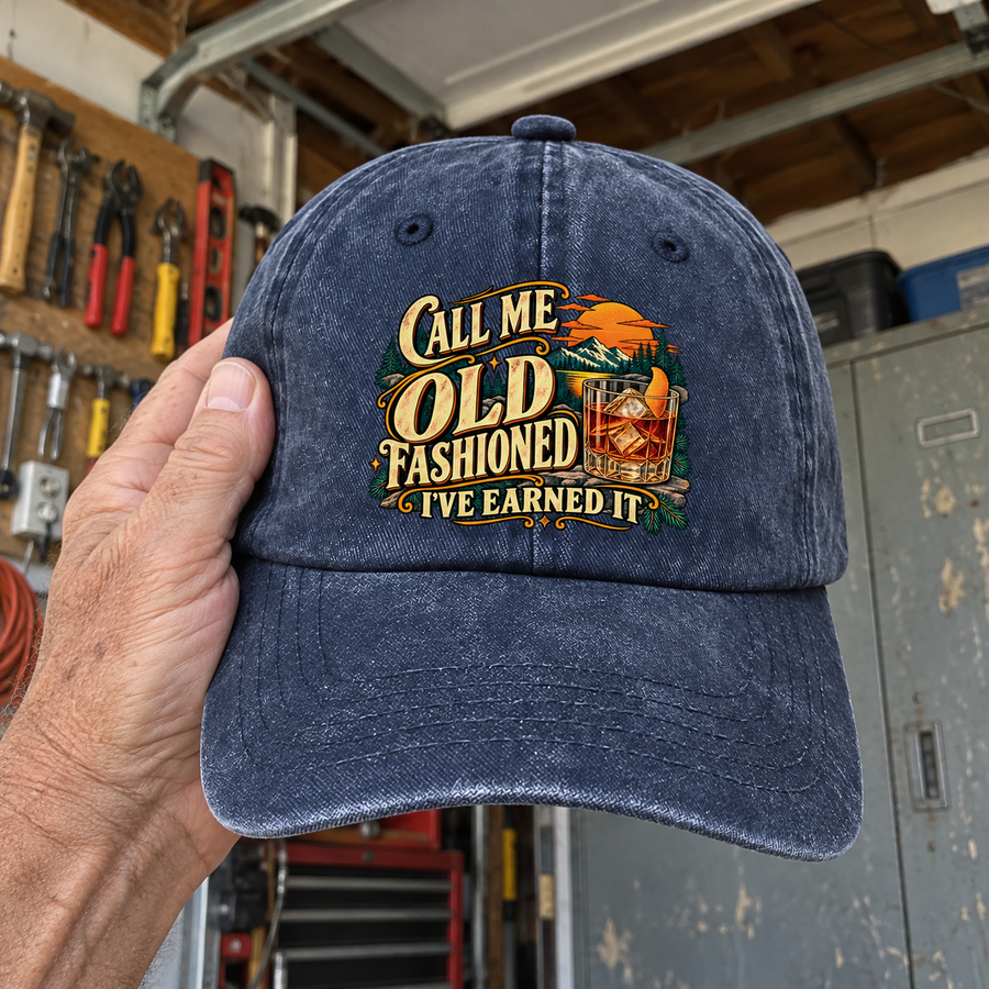 Handheld navy vintage washed cap with printed Call Me Old Fashioned I've Earned It slogan