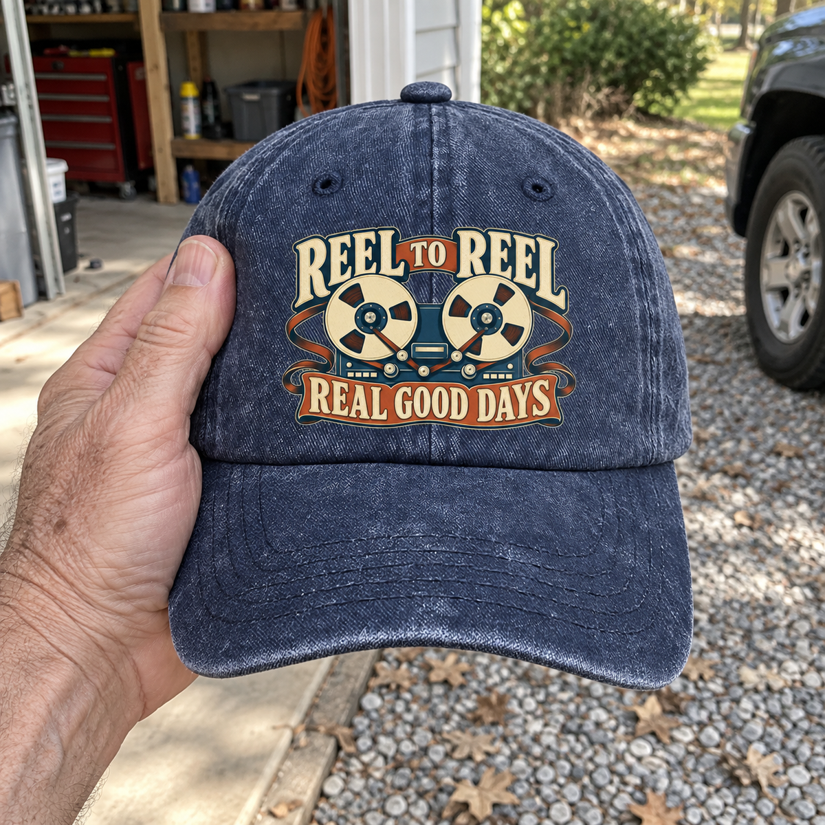Handheld navy vintage washed cap printed with Reel To Reel Real Good Days
