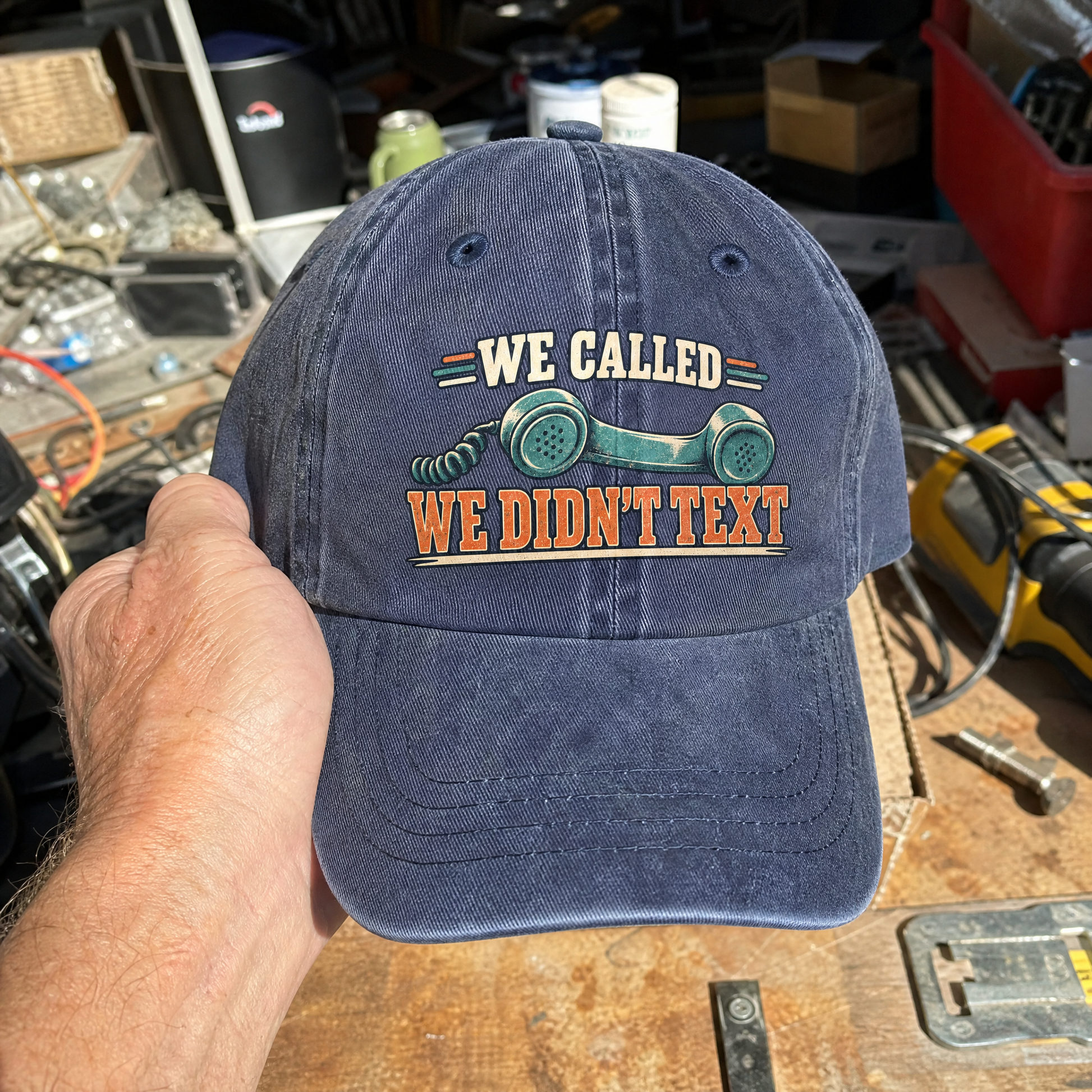 Vintage washed cap featuring printed “We Called. We Didn’t Text” slogan and telephone graphic, handheld