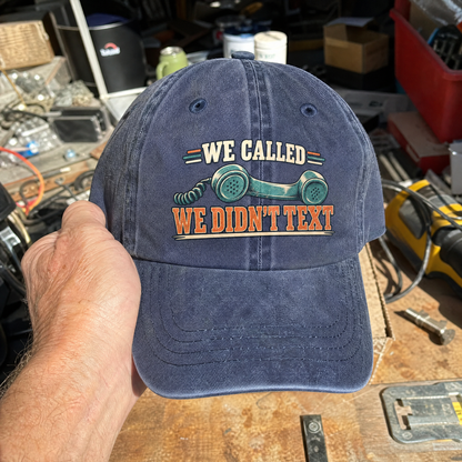 Vintage washed cap featuring printed “We Called. We Didn’t Text” slogan and telephone graphic, handheld