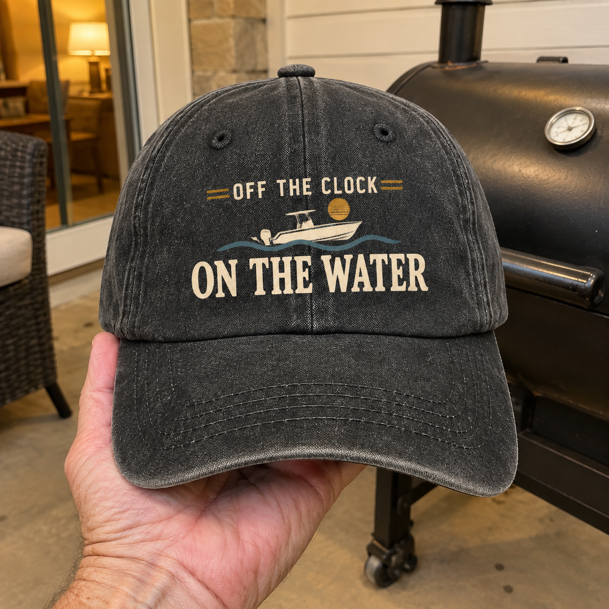 Black vintage washed cap with printed Off The Clock On The Water slogan, handheld front view