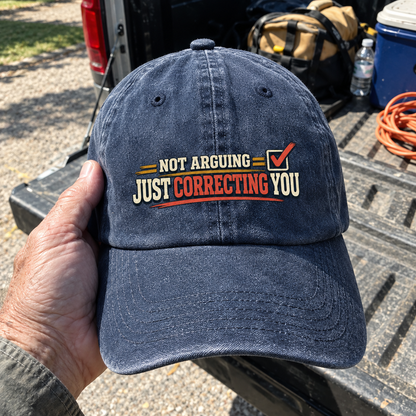 Vintage washed cap with printed Not Arguing Just Correcting You slogan, held outdoors