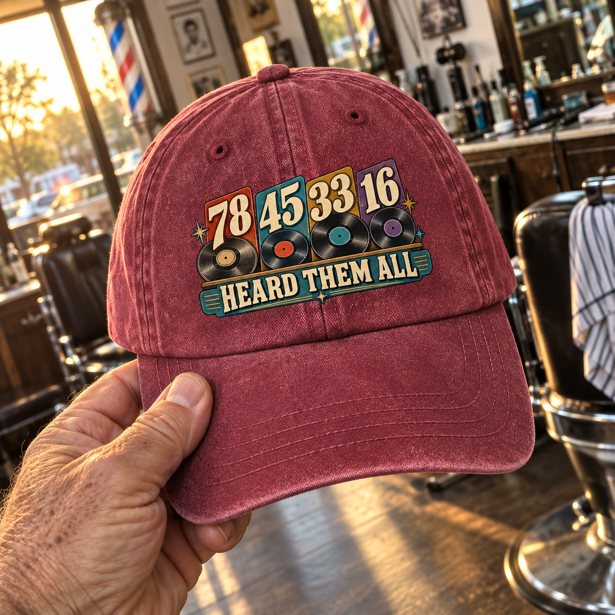 Handheld burgundy vintage washed cap printed with 78 45 33 16 and Heard Them All
