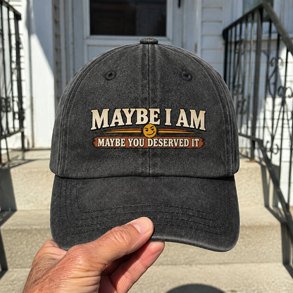 Black vintage washed cap with printed Maybe I Am slogan, handheld view