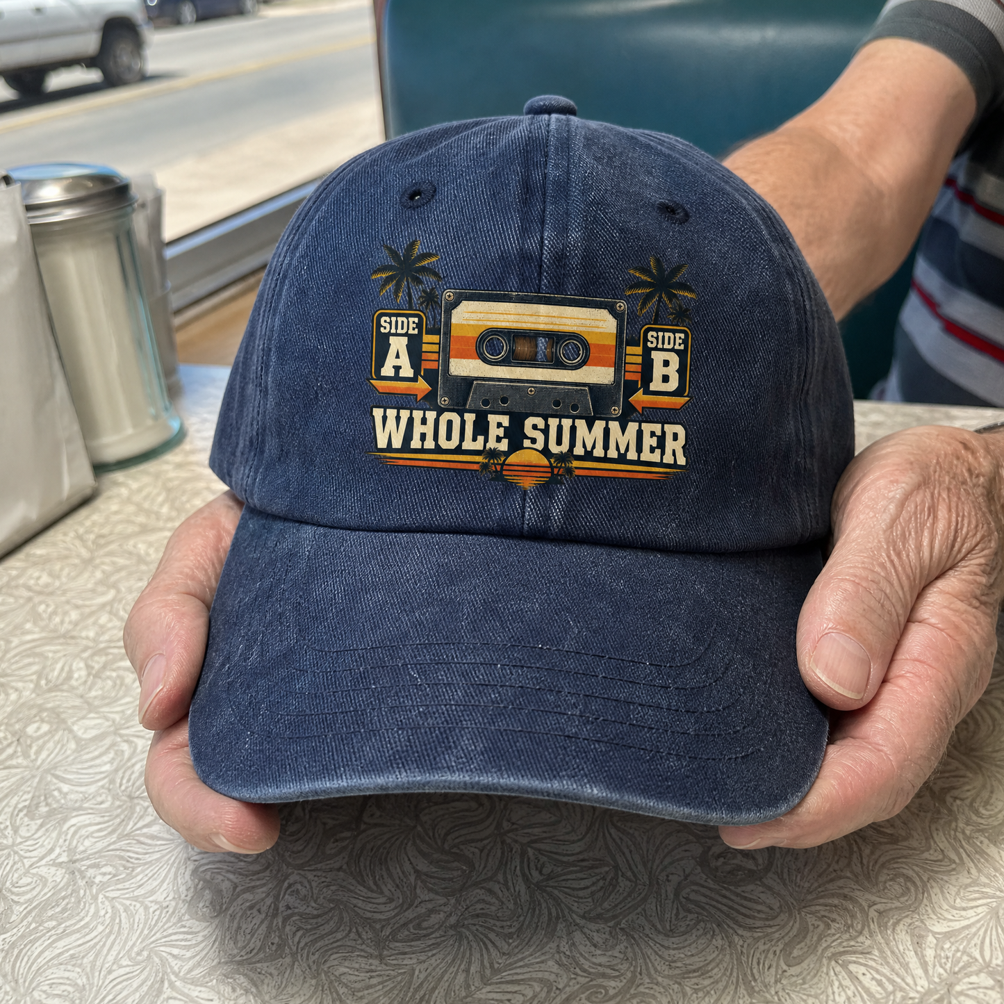 Vintage washed cap with printed “Side A Side B Whole Summer” slogan, handheld view