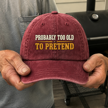 Burgundy vintage washed cap with printed Probably Too Cold To Pretend slogan, handheld view