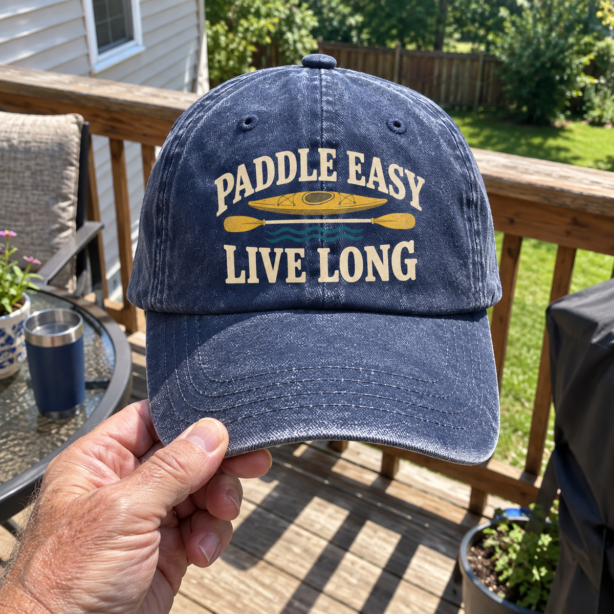 Blue vintage washed cap printed with Paddle Easy Live Long slogan, kayak design, handheld outdoors