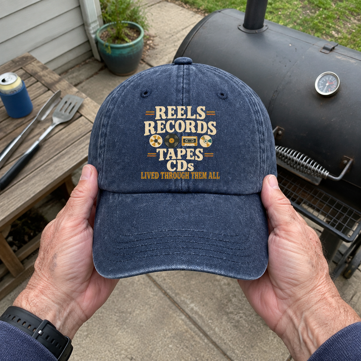 Navy vintage washed cap held outdoors with printed Reels Records Tapes CDs slogan