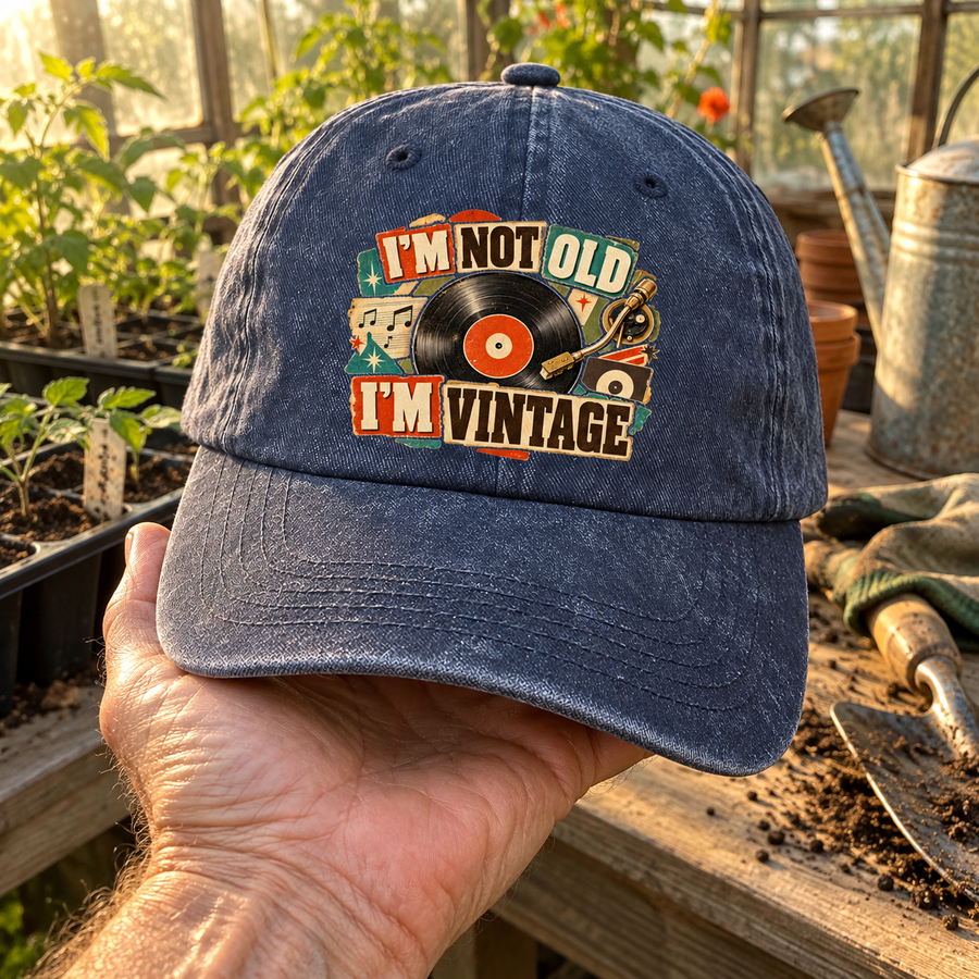 Handheld navy vintage washed cap with printed I'm Not Old. I'm Vintage record design.