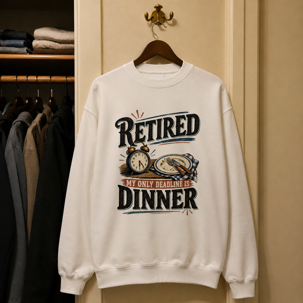 White vintage sweatshirt hanging with printed RETIRED and My Only Deadline Is Dinner slogan design