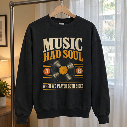 Black vintage sweatshirt with printed “Music Had Soul When We Played Both Sides” hanging.