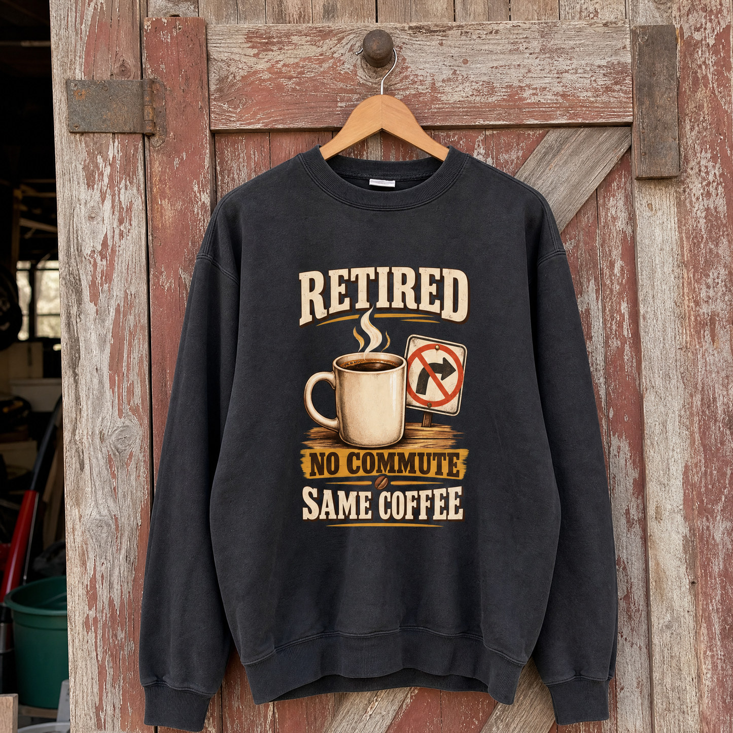 Black vintage sweatshirt hanging with printed Retired. No Commute Same Coffee slogan and coffee design.