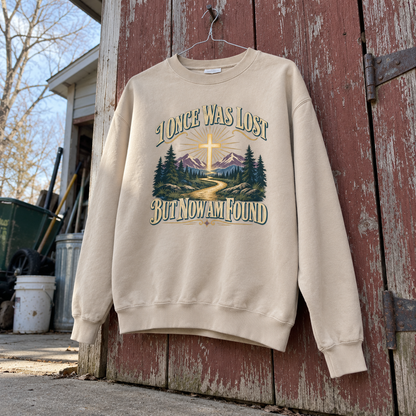 Cream vintage sweatshirt hanging, printed I Once Was Lost But Now Am Found with cross