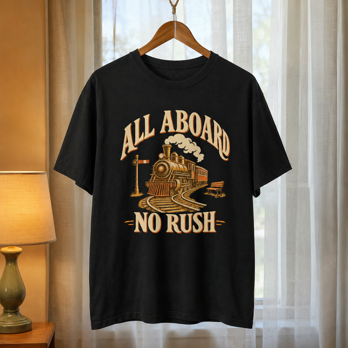 Black vintage t-shirt hanging with printed steam train design and All Aboard No Rush slogan