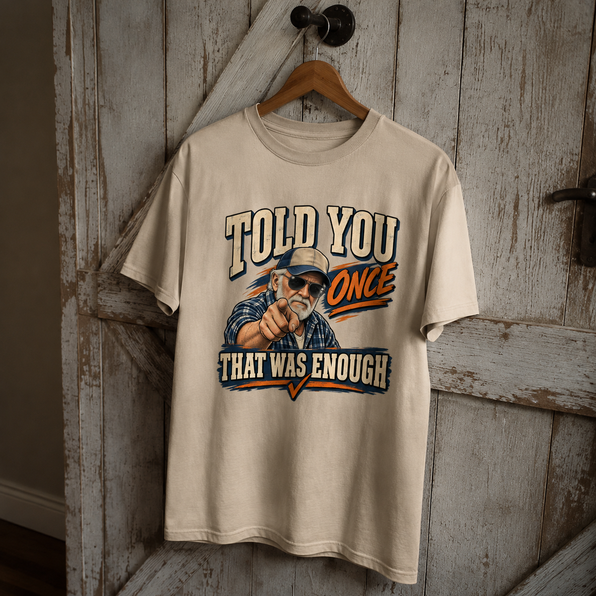Cream vintage t-shirt hanging with printed Told You Once That Was Enough graphic design