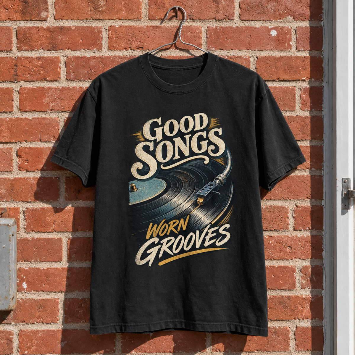 Black vintage t-shirt hanging with printed Good Songs Worn Grooves vinyl record design