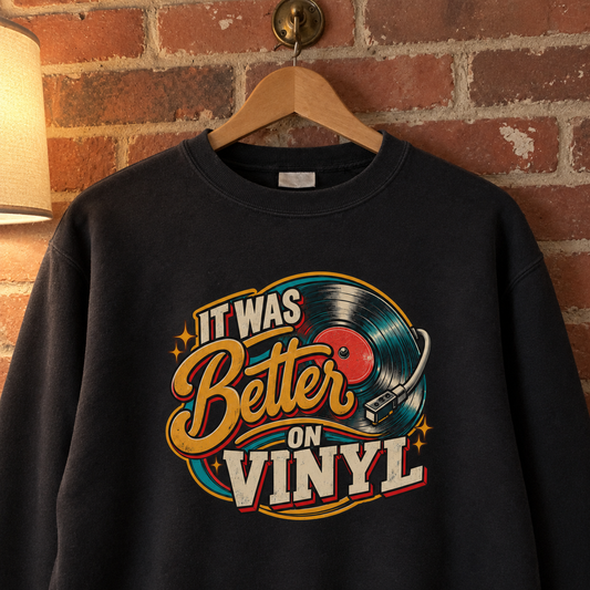 Black vintage sweatshirt hanging against brick wall with printed It Was Better On Vinyl design