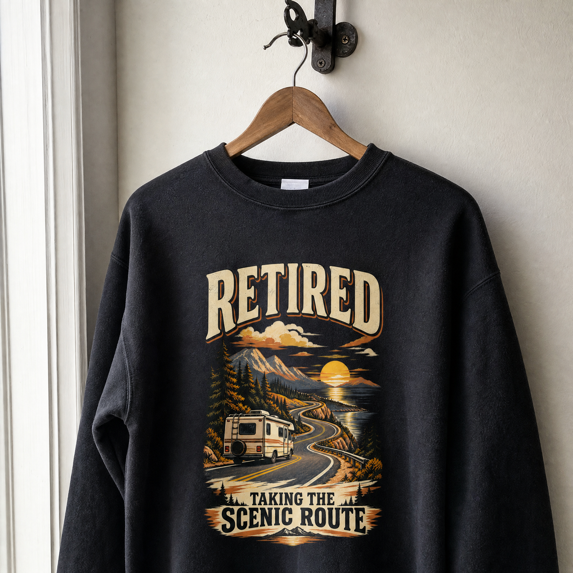 Black vintage sweatshirt with printed “Retired Taking the Scenic Route” mountain and RV design hanging