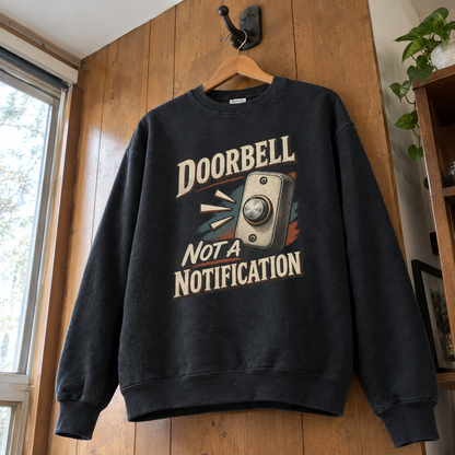 Black vintage sweatshirt hanging, printed with Doorbell Not A Notification and doorbell graphic