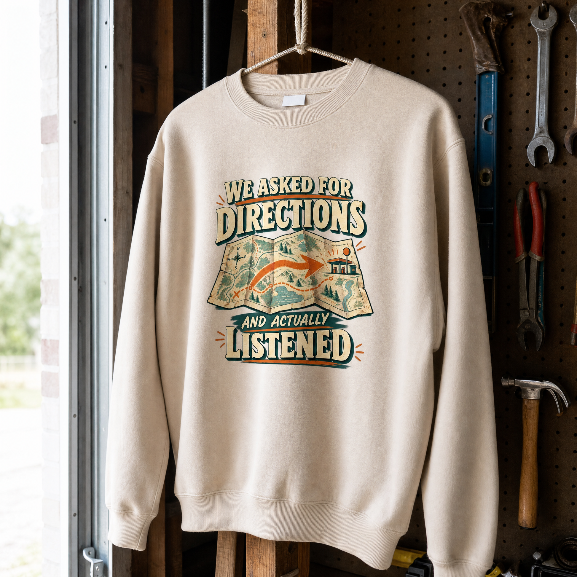 Cream vintage sweatshirt hanging with printed We Asked For Directions And Actually Listened design