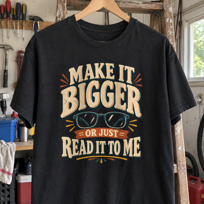 Black vintage t-shirt hanging in a workshop with printed glasses and bold lettering