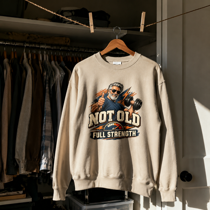 Cream vintage sweatshirt hanging with printed Not Old Full Strength design and senior man graphic
