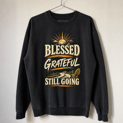 Black vintage sweatshirt hanging with printed Blessed Grateful Still Going slogan and mountain design